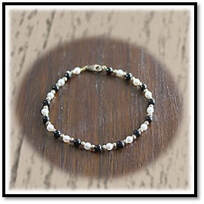 Main page item 9ct yellow gold pearl & onyx bracelet $480A